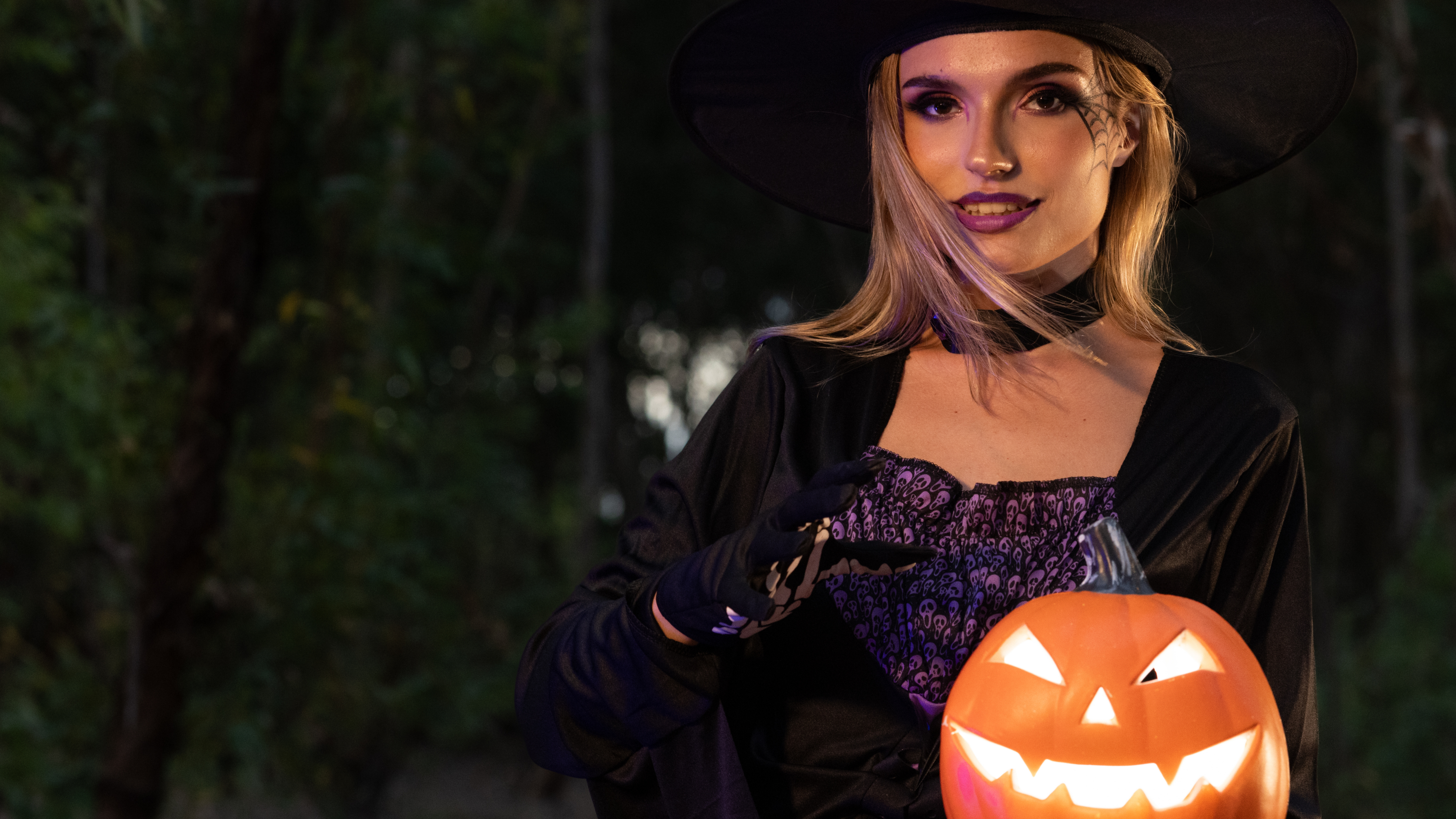 Halloween witch holding jack-o-lantern, wide banner. 30% off all plugins.